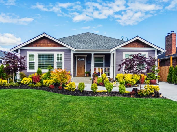 photo of a modern custom single level suburban home on a sunny summer day
