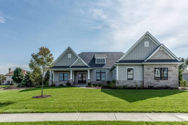 sidewalk passing through neighborhood with huge grassy lawn in front of home